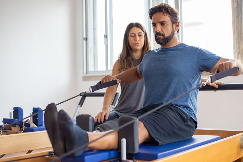 Patient doing rehab exercise with therapist guidance